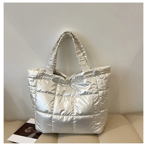 Detailed view of champagne gold quilted puffer tote bag with ruched handles for winter