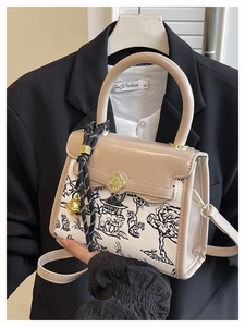 Detail of crossbody bag with oriental landscape print and clover metal clasp buckle