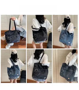 Detail view of denim tote bag with round coin purse attachment and zipper pocket