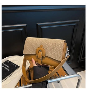 Close-up of the woven texture and smooth leather finish on this stylish crossbody bag