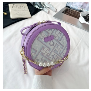 Detail of purple round crossbody bag with embroidery and luxury pearl chain strap