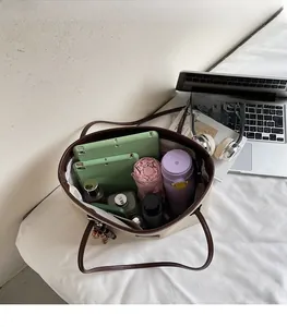 Interior view of large beige canvas tote bag showing spacious storage for office essentials