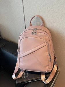 Pink lychee grain leather backpack with diagonal stitching and dual ring zippers