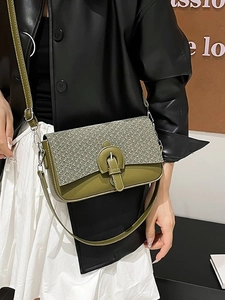 Olive green crossbody bag with textured weaving and circular buckle shown on model