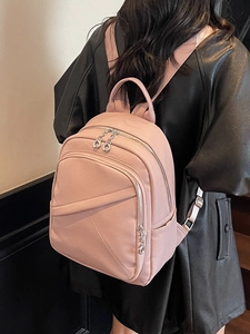 Dusty rose faux leather backpack for women with diagonal zipper and top handle detail