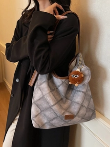 Retro blue quilted tote bag with brown leather trim and cute plush monster charm