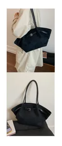 Detail of black suede tote bag with leather strap and buckle for commuting use