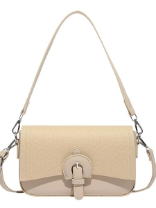 Minimalist beige crossbody bag with V-shaped texture and metallic buckle on white background
