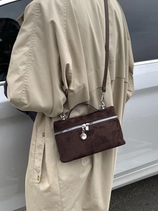 Chic dark brown matte square crossbody bag with silver zipper on stylish beige trench coat
