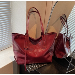 Deep burgundy glossy oil-waxed leather tote bag with elegant mirror reflection effect