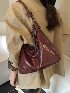 Vintage burgundy glossy patent leather underarm bag with knot detail on the strap