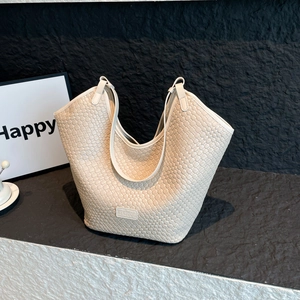 Dettaglio della borsa tote intrecciata crema con logo KENEDOU e artigianato in pelle