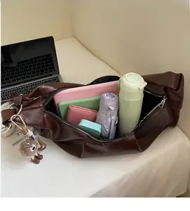 Deep brown oversized PU leather tote bag showing spacious interior with daily essentials