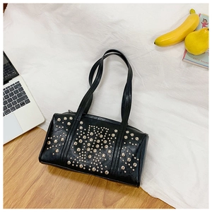 Detail view of black vintage leather tote bag with silver studs and double shoulder straps