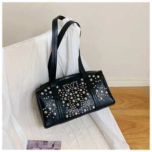 Close-up of a black Boston bag featuring polished silver stud rivets on premium leather