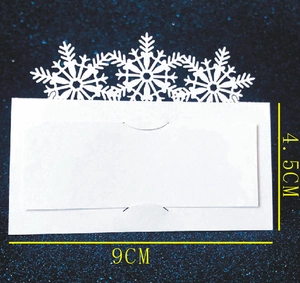 Elegant white laser-cut snowflake place cards for Christmas and winter wedding table decor