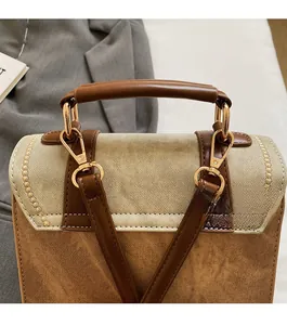 Detailed close-up of premium gold hardware and twill fabric texture on a retro backpack