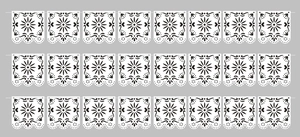 White laser-cut decorative paper banners with intricate floral patterns for party decor