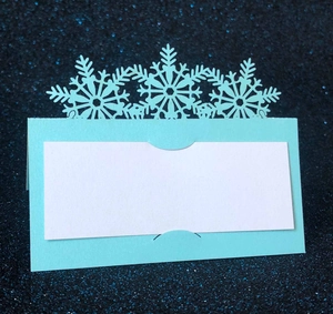 Laser cut snowflake place card in light blue for winter weddings and festive events