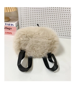Detail of the soft beige faux fur texture and black nylon straps on this trendy backpack