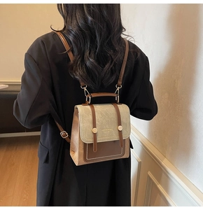 Detail of retro mini backpack with brown leather patchwork and adjustable straps