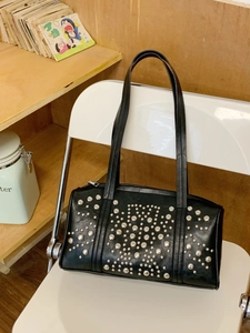 Fashionable black leather rivet shoulder bag with silver studs and spacious interior