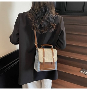 Rear view of a model wearing the vintage color-block handbag with adjustable brown straps