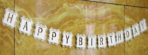 Détail de la banderole Happy Birthday avec dentelle découpée au laser et lettres blanches