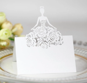 Detailed laser-cut white place card with elegant female silhouette on a vintage plate