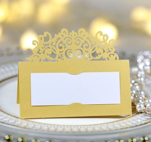 Détail du marque-place doré découpé au laser avec dentelle baroque et finition perlée