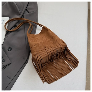 Detailed view of a brown suede mini bucket bag featuring elegant long fringe tassels