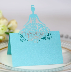 Detailed laser-cut light blue place card with floral dress female silhouette on a plate