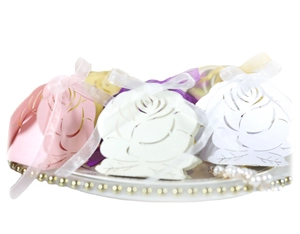 Laser cut hollow rose wedding favor candy boxes in pink and white with ribbons