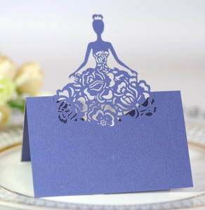 Macro shot of navy blue laser-cut place card with elegant floral silhouette detail