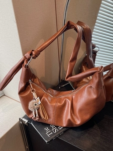 Brown vintage hobo shoulder bag with pleated design and plush bear charm for women