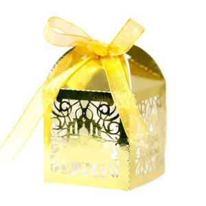 Golden laser-cut wedding favor box with palace patterns and elegant yellow satin ribbon