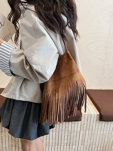 Brown suede shoulder bag with fringe detail and minimalist tote shape for women