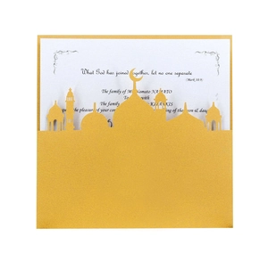 Macro detail of laser-cut gold greeting card with mosque silhouette and white insert