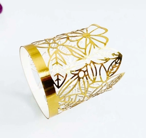 Detail of laser-cut floral pattern on golden paper decorative tea light candle wrap
