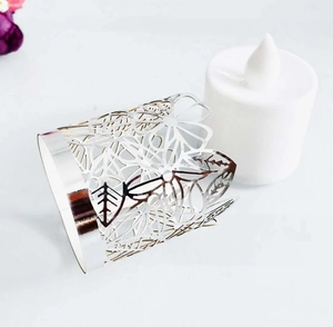 Macro detail of silver laser-cut hollow pattern on tea light candle shade holder
