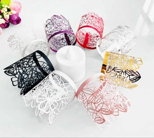 Laser-cut floral paper tea light shades in various colors around a white LED candle