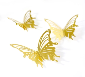 Detailed close-up of three gold hollow-out 3D metal butterfly wall stickers in varied sizes