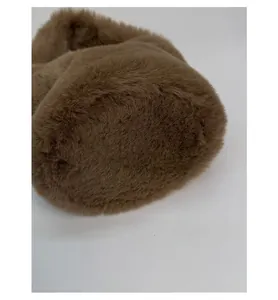 Macro detail of high-quality brown plush bucket bag showing soft faux fur texture