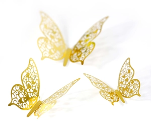 Detail of 3D gold hollow butterfly wall stickers with intricate heart pattern carvings