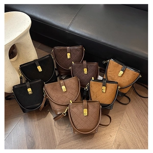 Detail showing various colors of quilted bucket bags with gold twist lock closures