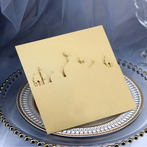 Golden laser-cut Eid Mubarak card with mosque silhouette on elegant tray display