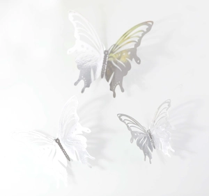 Detailed macro view of 3D metallic hollow butterfly wall stickers in varying sizes