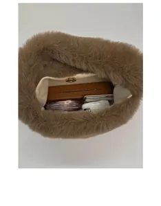 Top view of fluffy plush bucket bag interior showing large capacity and magnetic snap closure