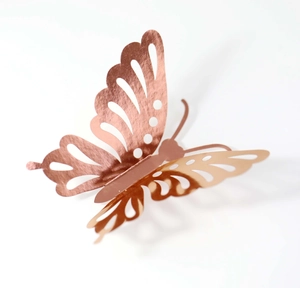 Close-up of rose gold 3D hollow butterfly wall sticker with detailed laser-cut wings texture