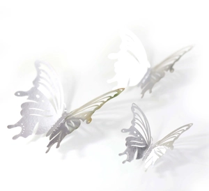 Detail of three 3D silver hollow butterfly wall stickers in varying sizes with metallic finish
